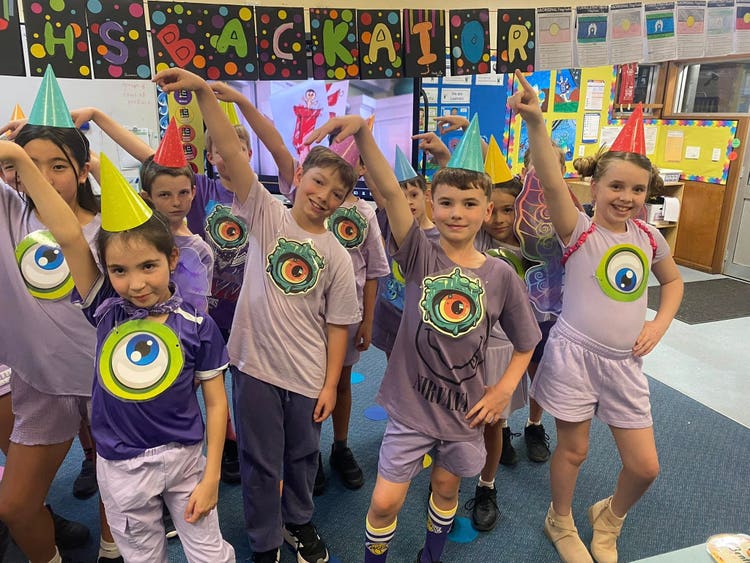 A class dressed in their purple