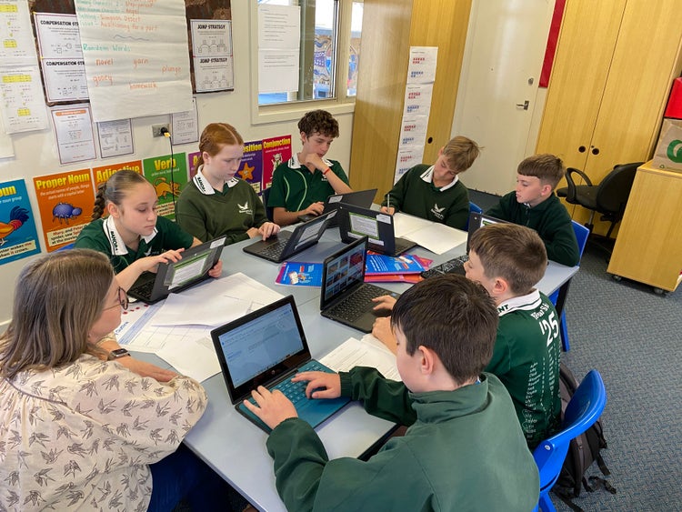 A group of students taking part in 'Write a Book in a Day' with the support of a teacher. Write a Book in a Day is an annual writing competition that gives students a chance to collaborate, flex their creativity and help make a difference to the lives of kids with cancer.