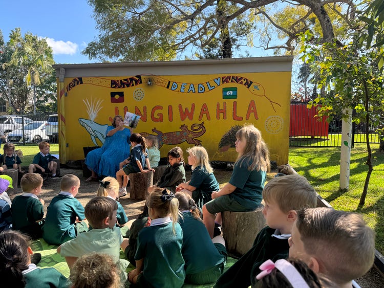 A teacher reading a story to Kindergarten students during Indigenous Literacy Storytime.