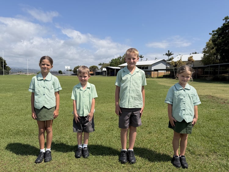 A group of students wearing the summer uniform.