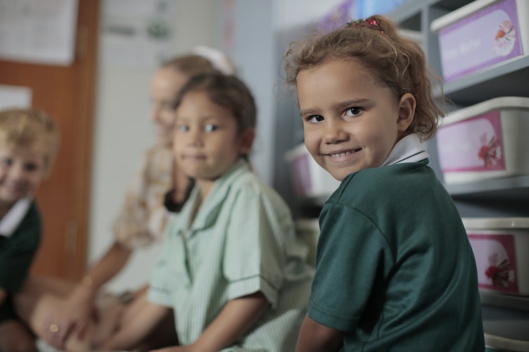 A young student looking at the camera happily.