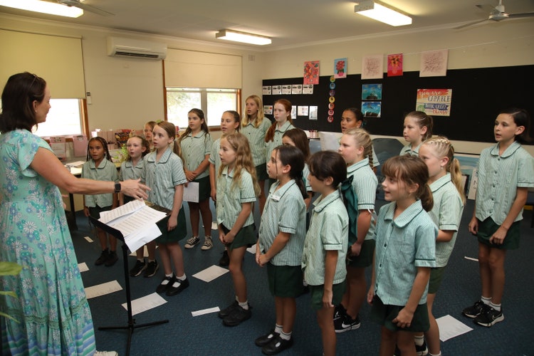 Our 3-6 choir group rehearsing with our choir teacher, Mrs Coram.