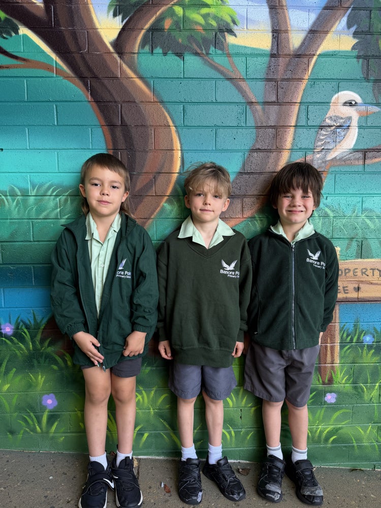 Three students wearing the winter uniform.