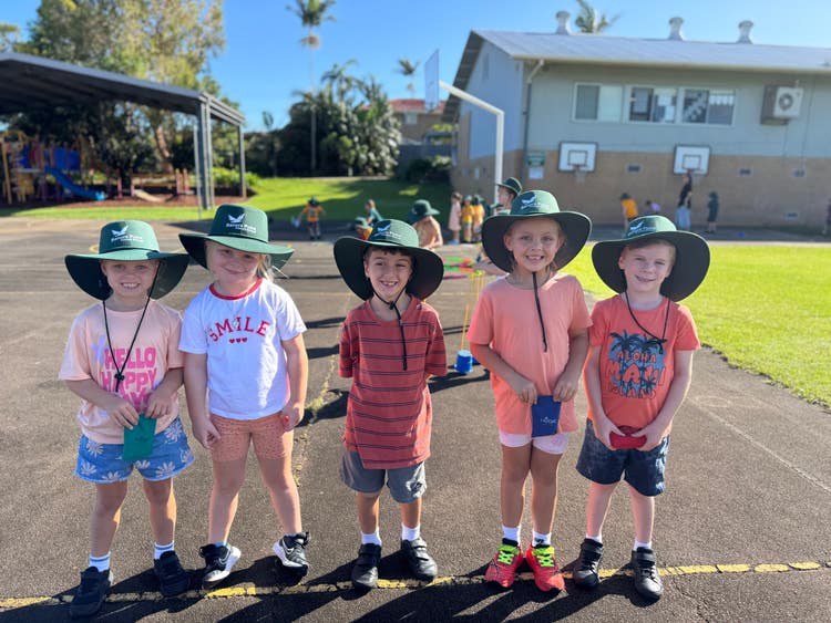 A group of students wearing orange to celebrate Harmony Day.