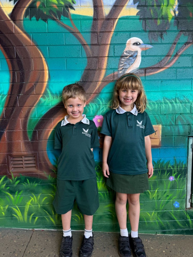 Two students wearing the sports uniform.