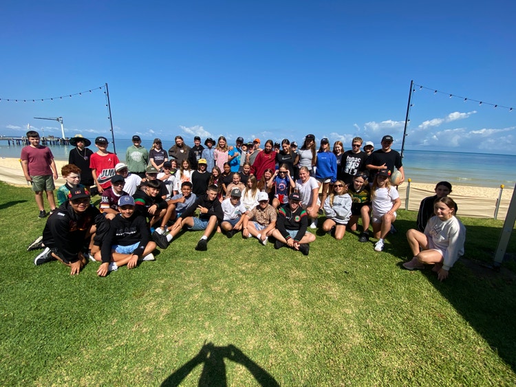 A group of students smiling at the camera at Tangalooma.