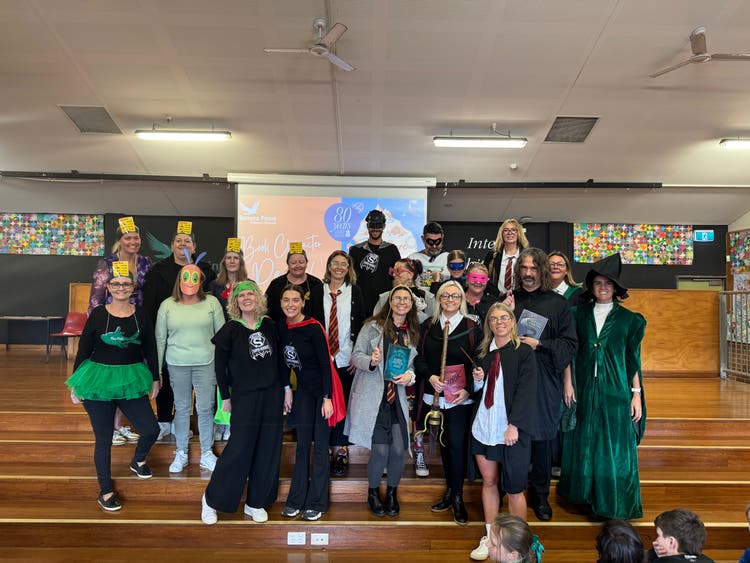 A group of teachers dressed up as various book characters.
